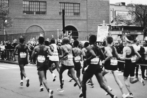 Black and white photo of runners participating in a marathon. from brand Elk Sports Nutrition .